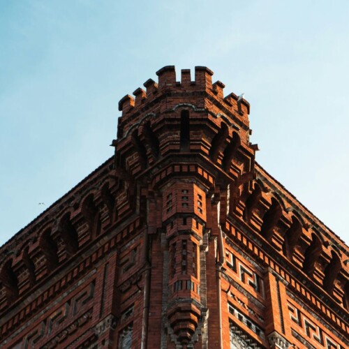 a very tall brick building with a clock on it